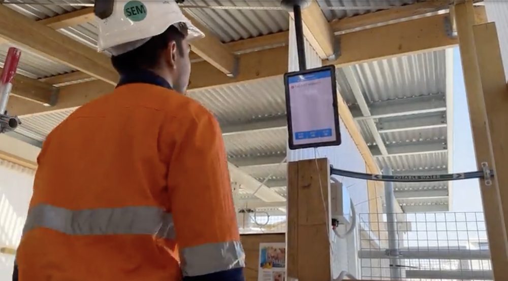 Site worker checking environmental conditions on a monitoring screen