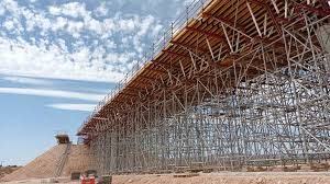 Timber scaffolding supporting a bridge under maintenance