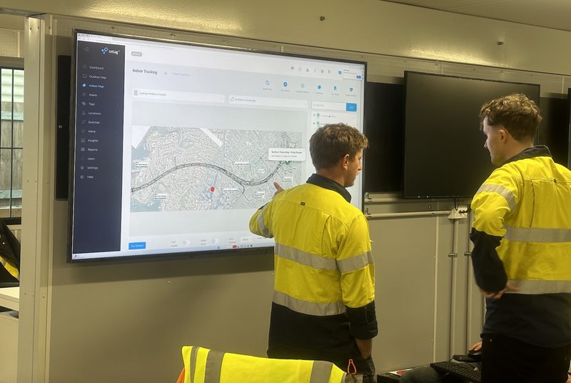 Operators reviewing a live operational map on a control-room screen